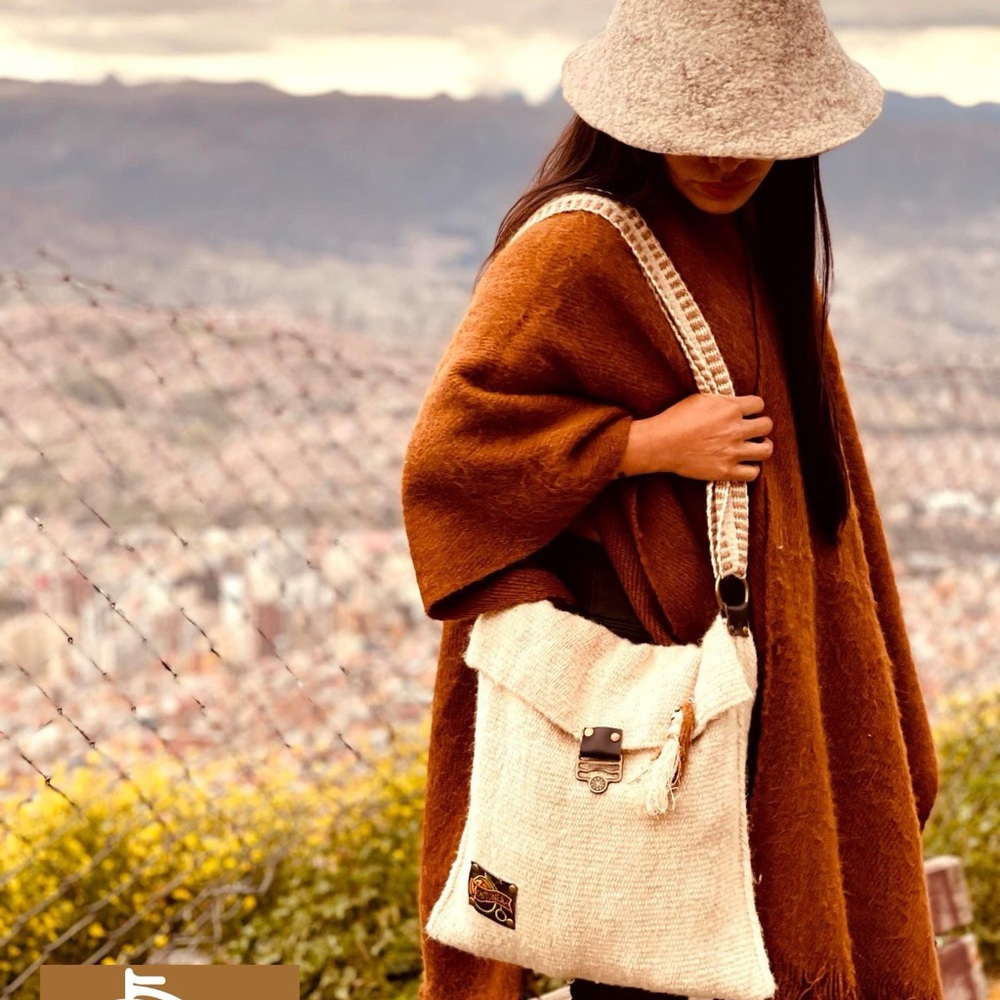 100% wool with genuine leather bag. Can also be used in bikes.